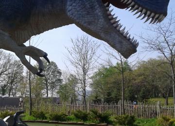 Nicole Shaw paints a three times larger than life-size T-Rex dinosaur in a mini putt in Niagara Falls Ontario Canada