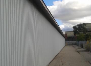 Nicole Shaw paints exterior corrugated metal