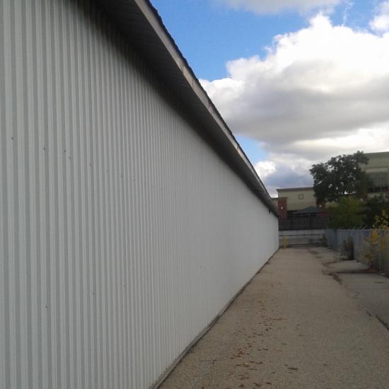 Nicole Shaw paints exterior corrugated metal
